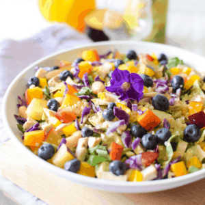 A picture of a cannabis rainbow chicken salad in a white bowl.