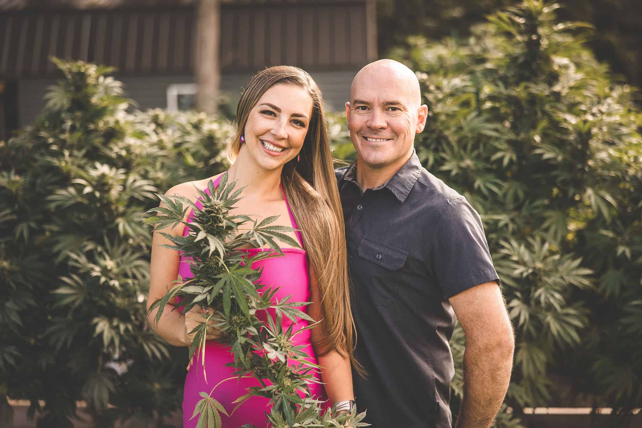 A picture of Emily Kyle and Phil Kyle with cannabis plants.